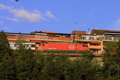 Train against buildings and blue sky