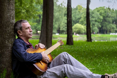 Full length of man sitting in park