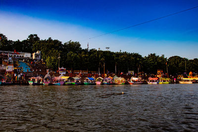 Boats moored in river against sky