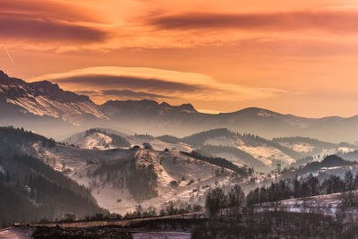 Scenic view of snowcapped mountains against sky during sunset