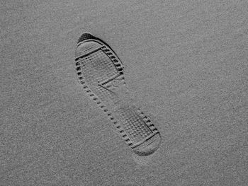 High angle view of footprints on sand