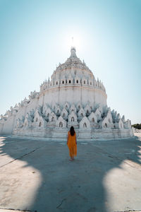Rear view of woman in temple against clear sky