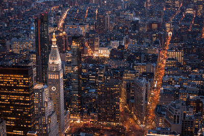 High angle view of city lit up at night