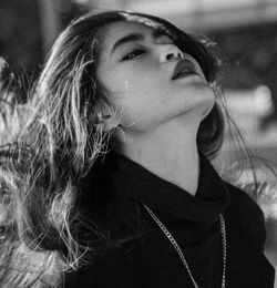 Close-up portrait of young woman looking away