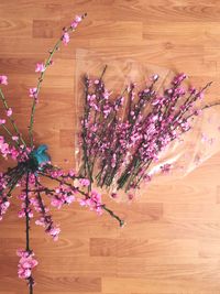 High angle view of pink flowering plant on wooden table