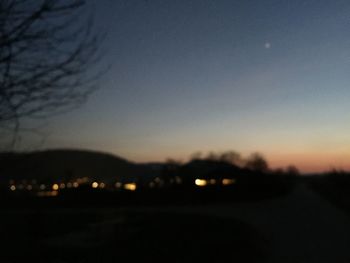 Silhouette landscape against sky at night