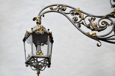 Close-up of metal hanging against sky