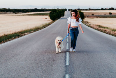 Portrait of man with dog on road