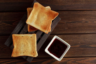 Toasts with jam on dark wooden table