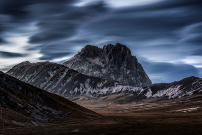 Scenic view of mountains against cloudy sky