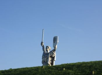 Low angle view of statue against clear blue sky