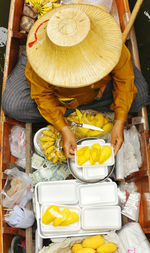 Full length of woman eating food in market