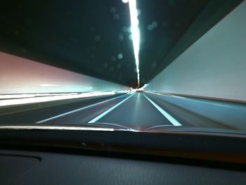Illuminated road seen through car windshield