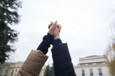 Low section of man holding hands