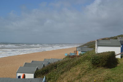 High angle view of cabins at beach against cloudy sky