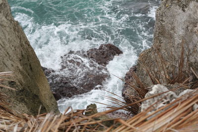 High angle view of rocks by sea