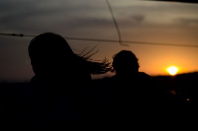 Silhouette people against sky during sunset