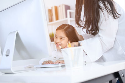 Portrait of smiling woman sitting on table