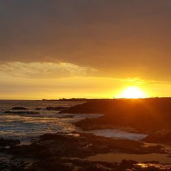 Scenic view of sea at sunset