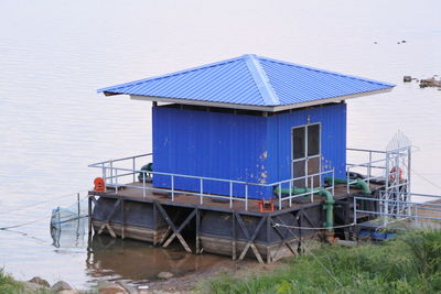 Built structure on beach by sea against sky