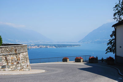 Road by sea against blue sky