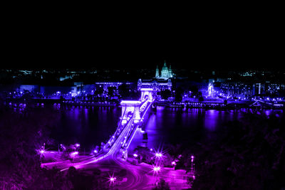 High angle view of illuminated bridge over river at night