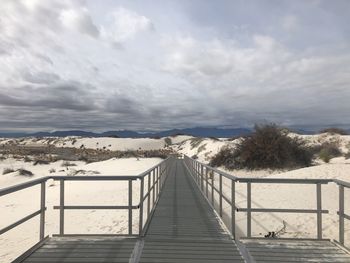 Scenic view of snow covered land against sky