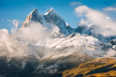 Scenic view of snowcapped mountains against sky