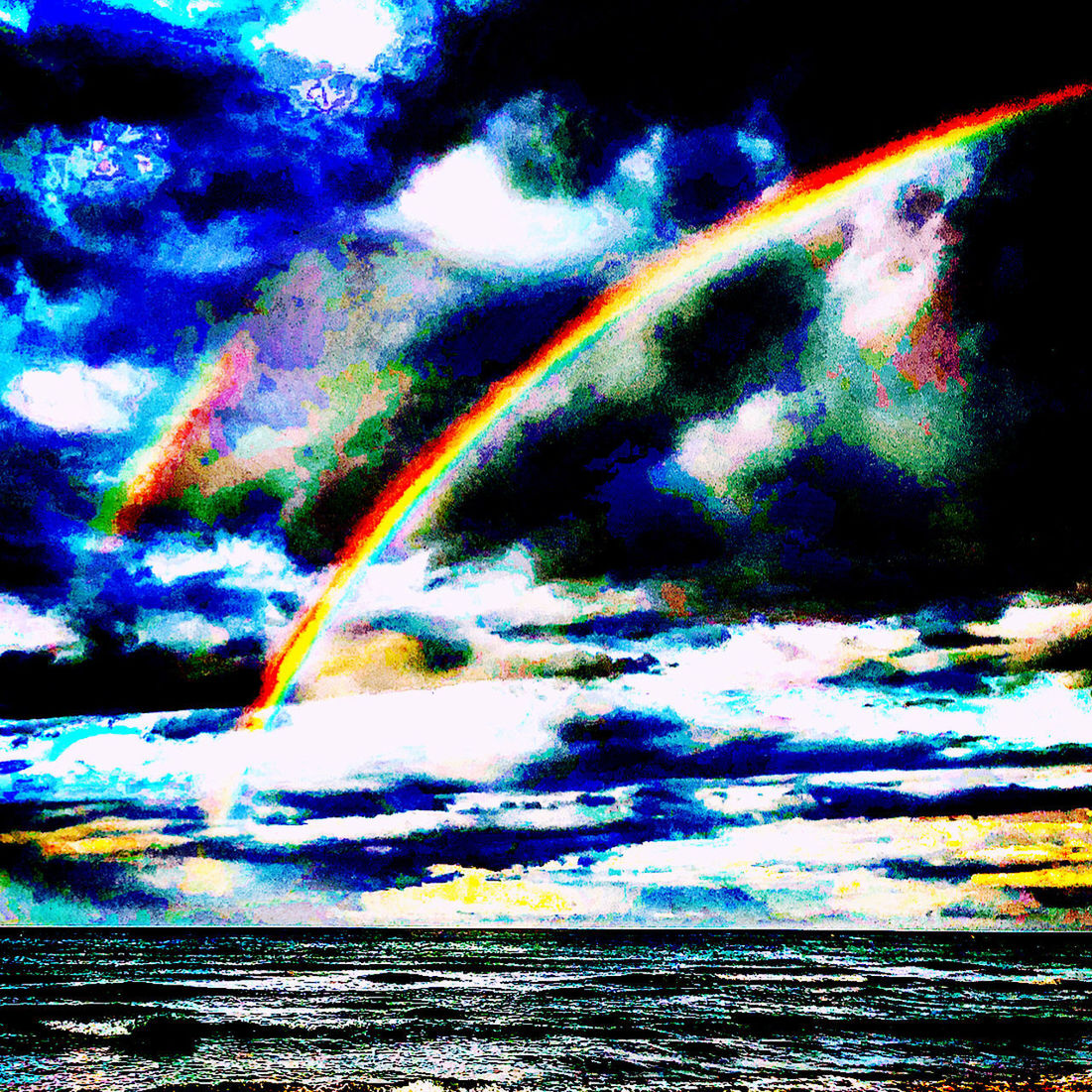 LOW ANGLE VIEW OF RAINBOW OVER SEA AGAINST SKY