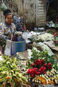 Portrait of woman for sale at market stall