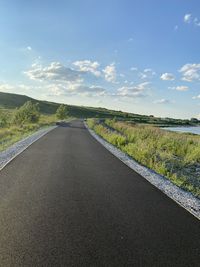 Empty road along countryside landscape