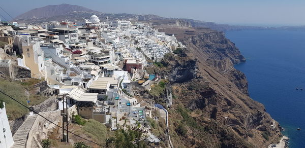 High angle view of townscape by sea against sky