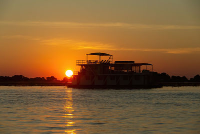 Scenic view of sea against orange sky