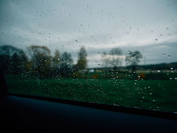 Raindrops on glass window of rainy season