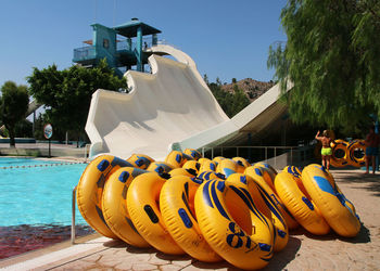 People by swimming pool against sky