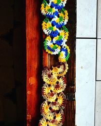 Close-up of multi colored flowers on wooden door