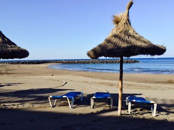 Tranquil view of beach against clear sky