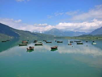 Boats moored in lake against sky