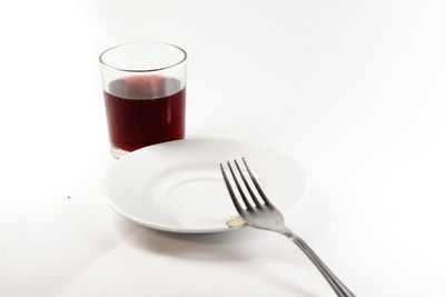 Close-up of tea cup over white background