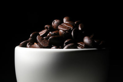 Close-up of coffee beans against black background