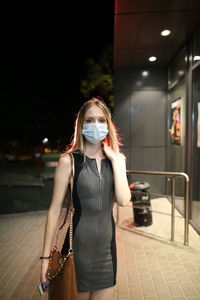 Girl in a mask in the evening on the street. covid-19, coronavirus. high quality photo