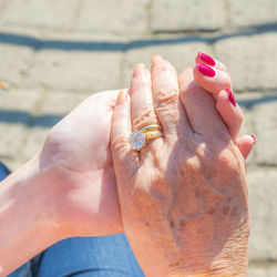 Close-up of women holding hands