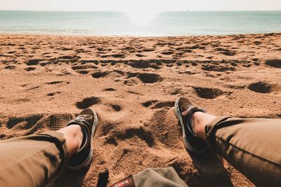 Low section of people relaxing on beach