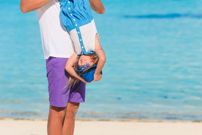 Low section of couple on beach