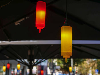 Low angle view of illuminated lights hanging from ceiling