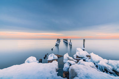 Scenic view of frozen sea against sky during sunset