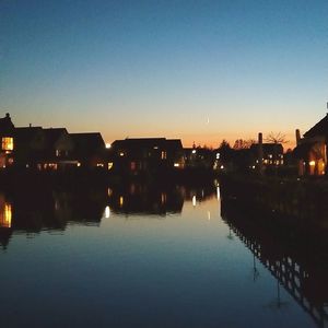 Reflection of illuminated buildings in lake at night