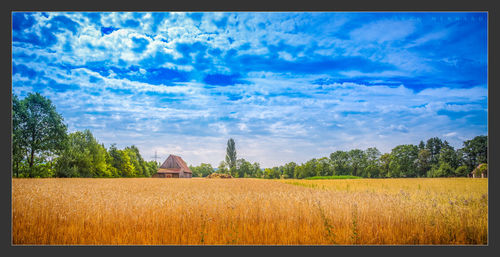 View of rural landscape against cloudy sky