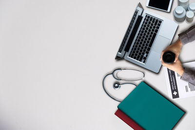 Digital composite image of laptop on table against white background