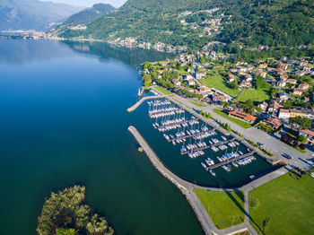 High angle view of lake amidst trees and buildings